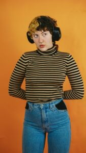 Nonbinary person with headphones Photo by Hiki App on Unsplash